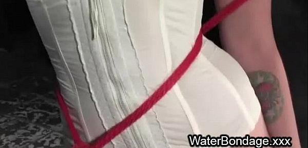  Bound brunette in red rope in water sink